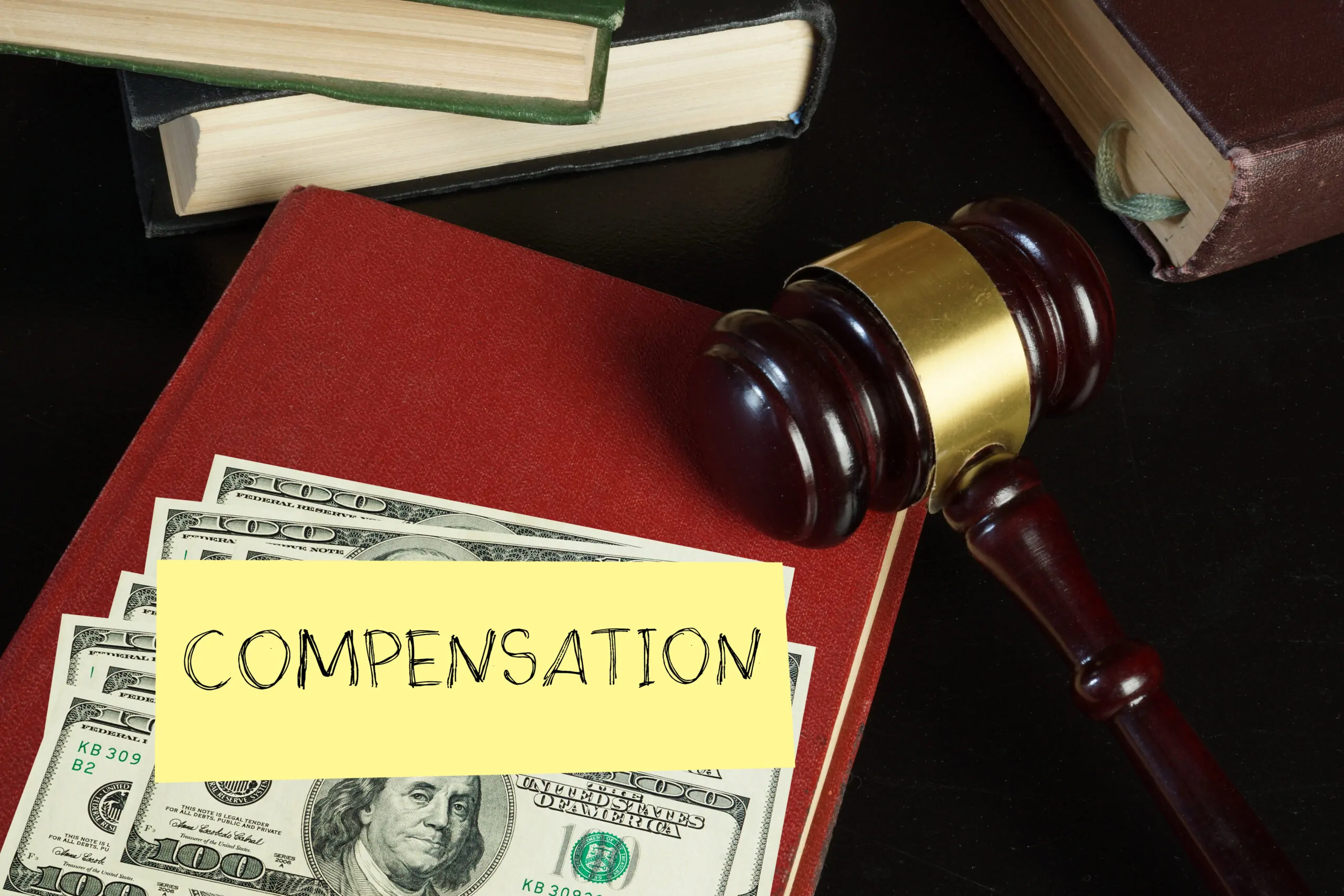 Compensation and judge's gavel Moral financial compensation for caused damage Lawyer services and Workers compensation